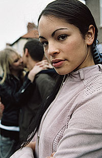 Picture of a girl, with a couple in the background